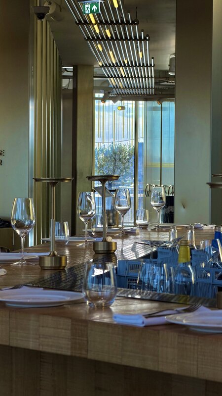The set table at Mr Porter, the rooftop steakhouse at the W Amsterdam, glassware catching the evening light