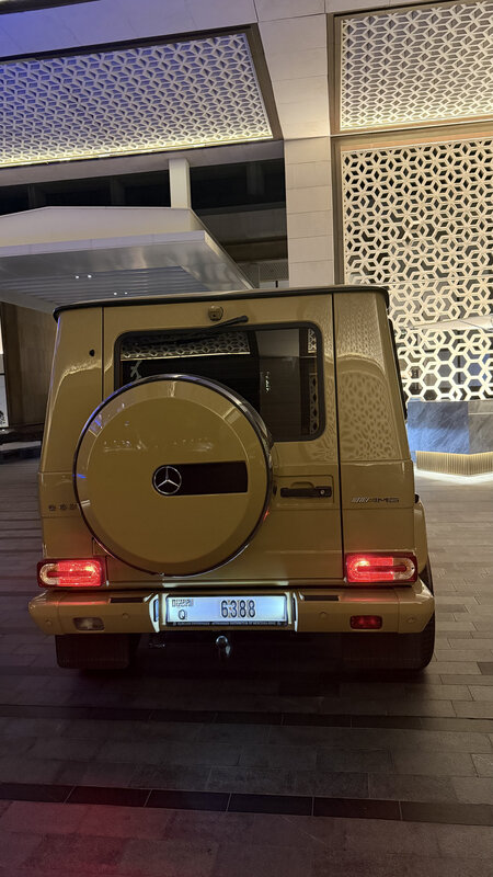 Sand-coloured Mercedes G-Wagon parked at Atlantis the Palm — Dubai plate, geometric mashrabiya wall behind