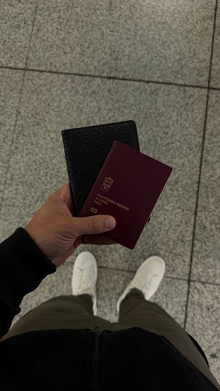 Swedish passport and leather holder at the airport — heading to Dubai