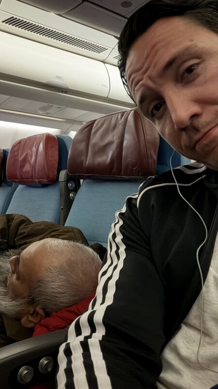 Jimmy Heneidy selfie on the plane to Dubai in Adidas track jacket