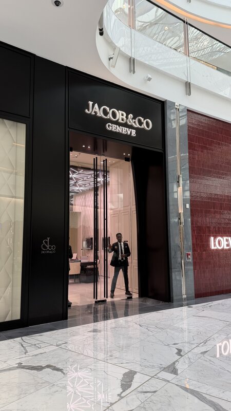 Jacob & Co Genève boutique entrance in Dubai — black glass storefront with brand signage