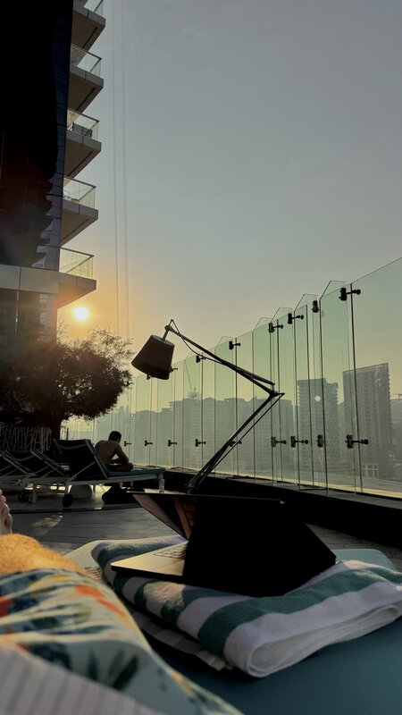 Sunset at Paramount Hotel rooftop pool — loungers and Dubai skyline