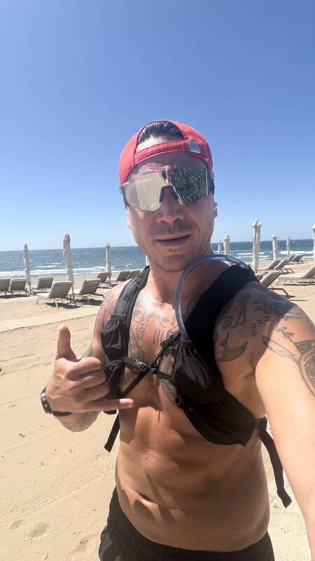 Jimmy on the beach in a hydration vest