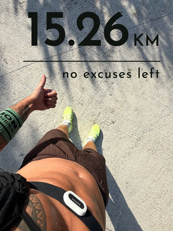 Looking down at neon running shoes on hot concrete under palm shadows, a thumbs up in the frame, with the card text: 15.26 km, no excuses left