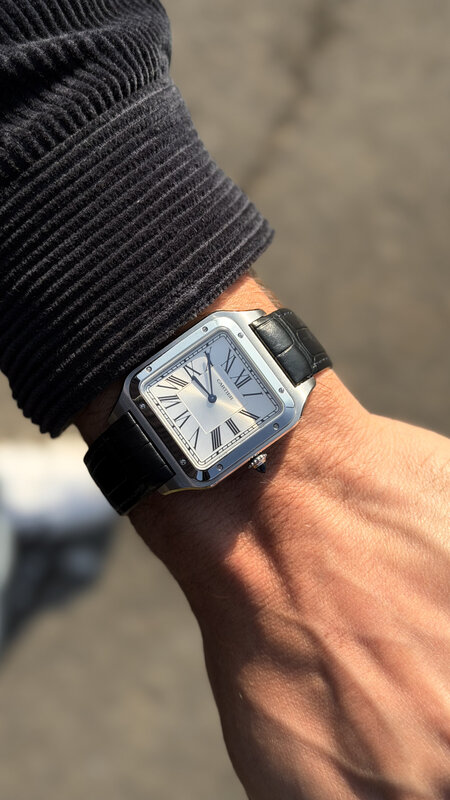 Cartier Santos watch on wrist with black leather strap