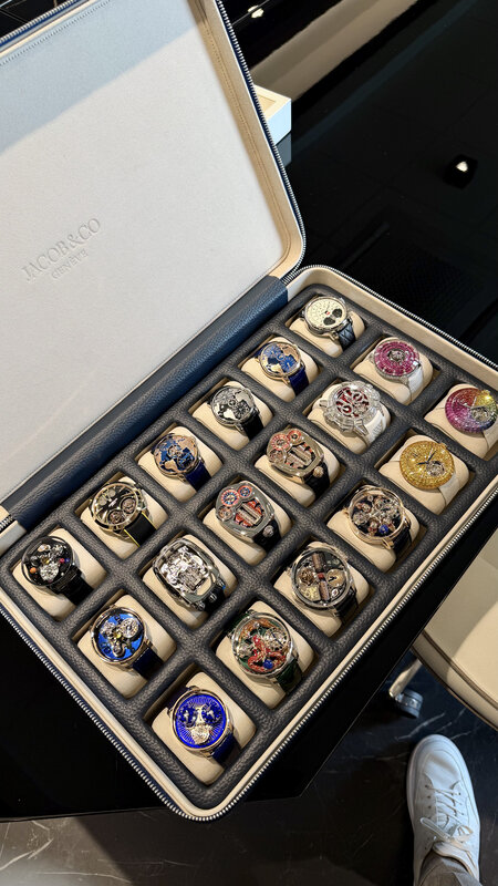 Open Hysek presentation case with rows of independent watches — colourful enamel and gem-set dials