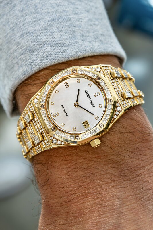 Audemars Piguet Royal Oak in yellow gold with diamond bezel and Mother of Pearl dial on wrist
